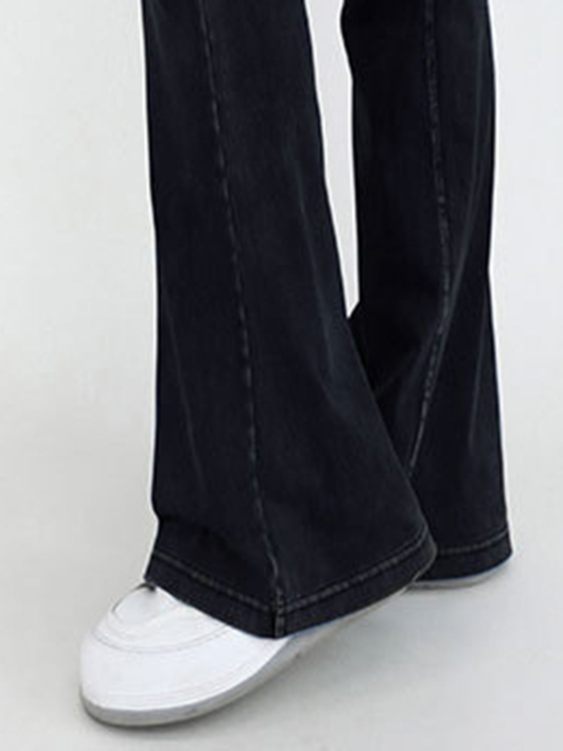 Crossover waist flare jeans in dark wash denim with a subtle flare and contrast stitching.