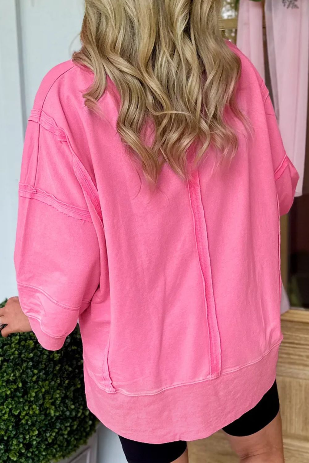 Pink tee with raw edge seam details and a relaxed fit.