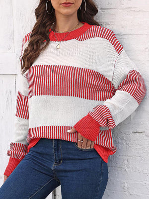 Striped knit crewneck sweater in red and white with ribbed trim and cuffs.