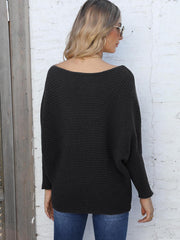 Black ribbed dolman knit sweater with off-the-shoulder neckline and wide sleeves.