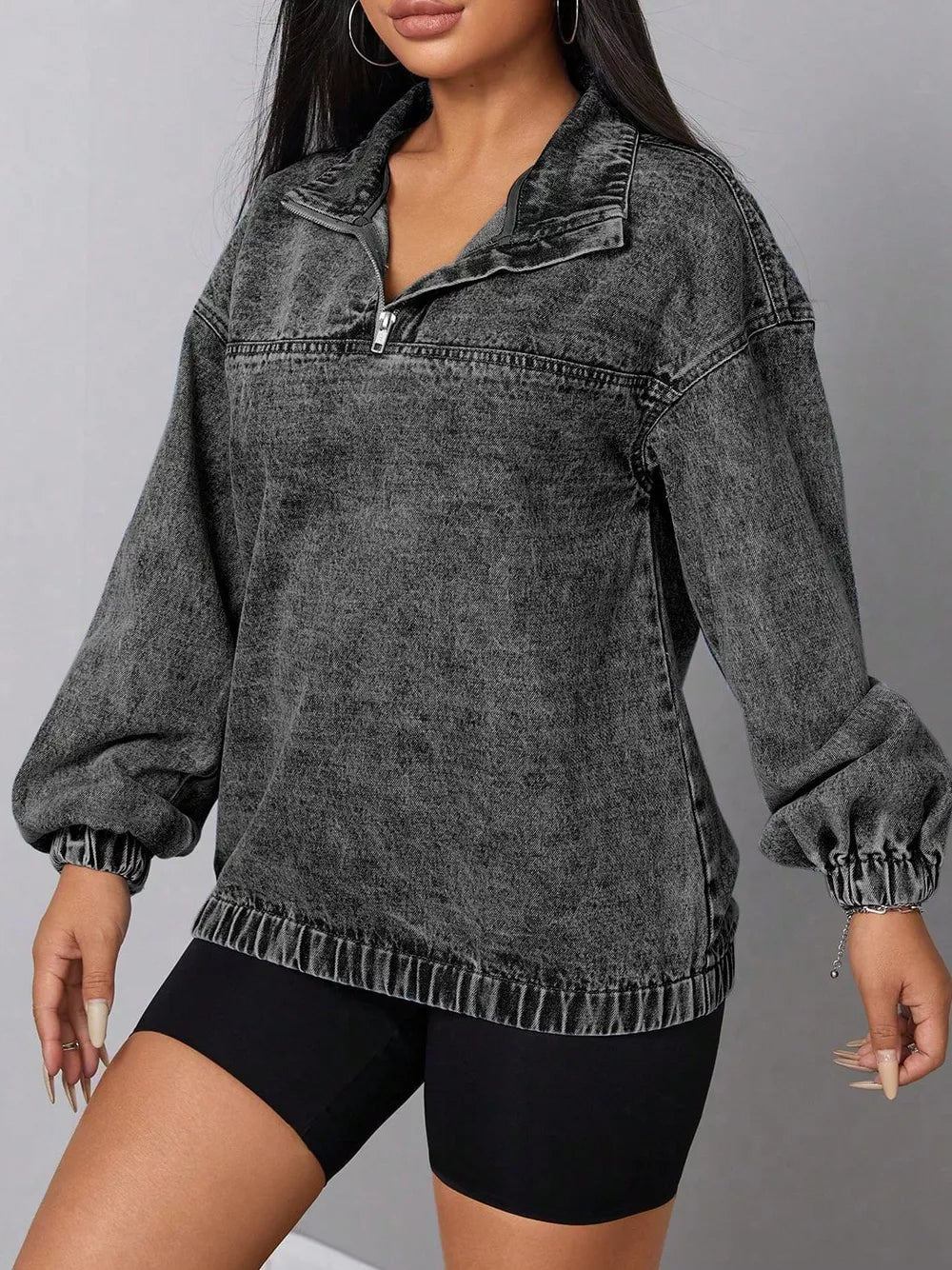 Chic quarter-zip denim top in dark gray acid wash with elastic hem and cuffs.