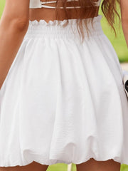 White bubble hem mini skirt with smocked waist and textured fabric