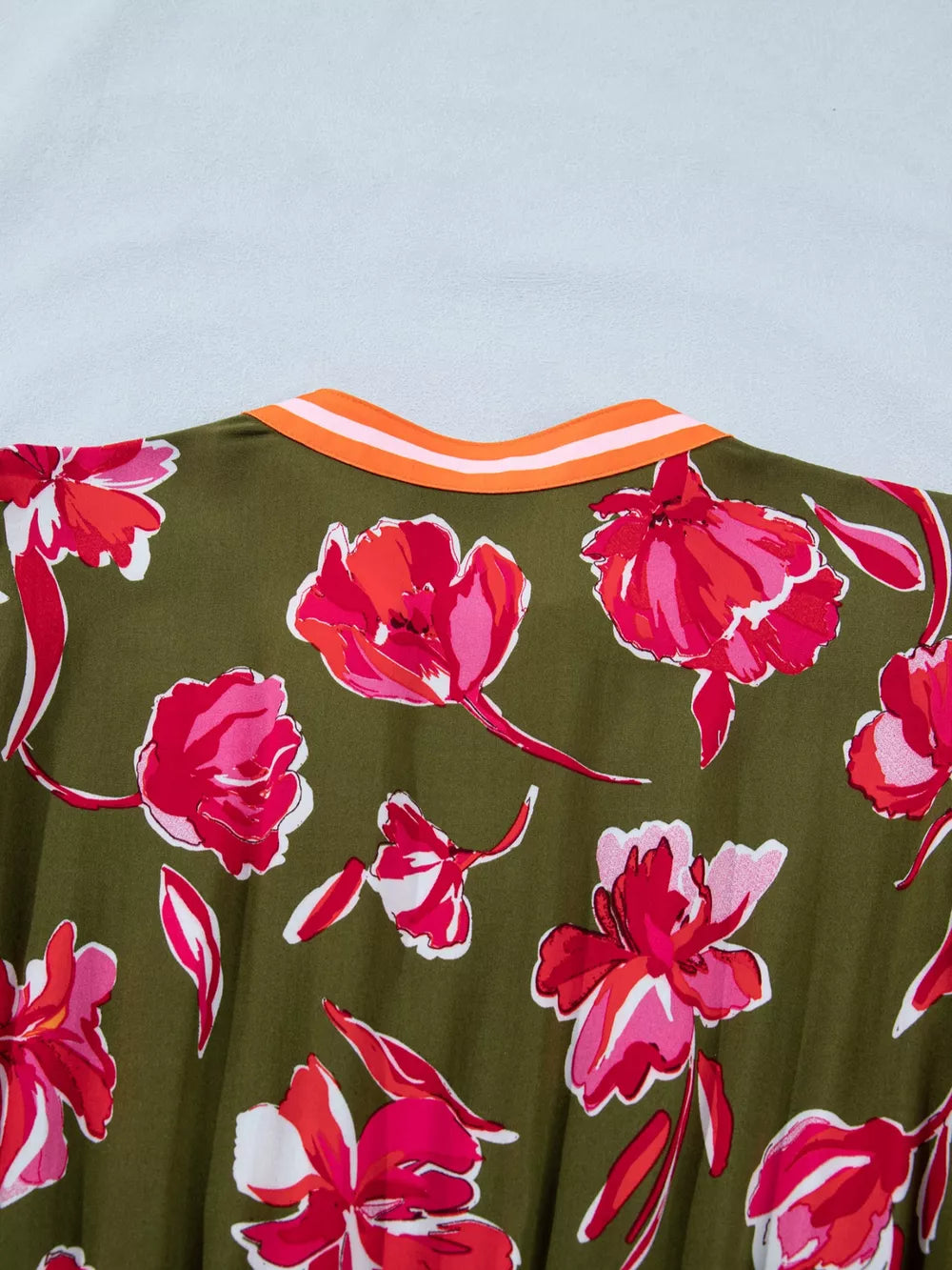 Print split neck dress in olive green with a bold floral print and striped neckline detail.