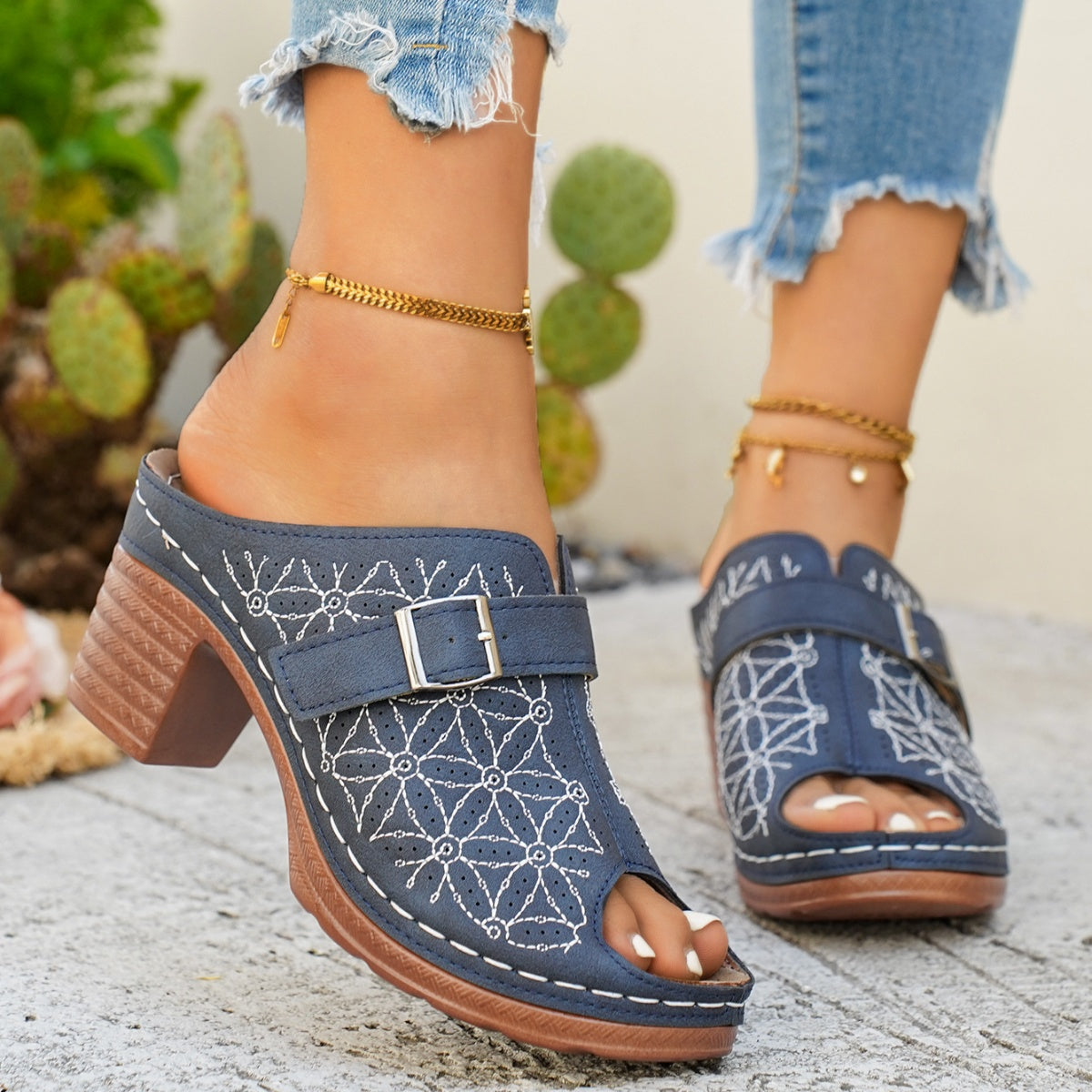 Blue buckle-embellished mid heel sandals with white floral embroidery and peep toe.