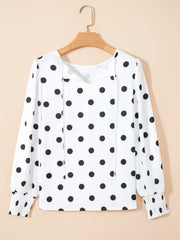 White polka dot blouse with tie neck and smocked cuffs