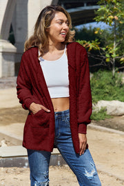 Plush hooded cardigan jacket in burgundy with pockets and long sleeves.