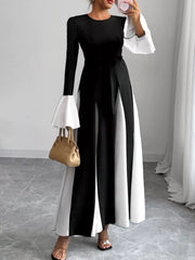 Black maxi dress with tie waist and white flare sleeves.