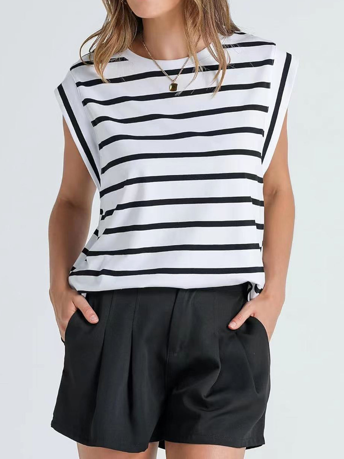 Padded shoulder tank top with black and white Breton stripes and cap sleeves.