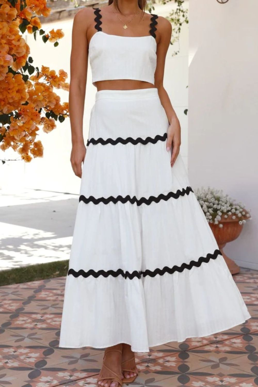 White crop top and tiered maxi skirt set with black scalloped trim detail.