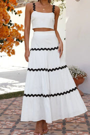 White crop top and tiered maxi skirt set with black scalloped trim detail.