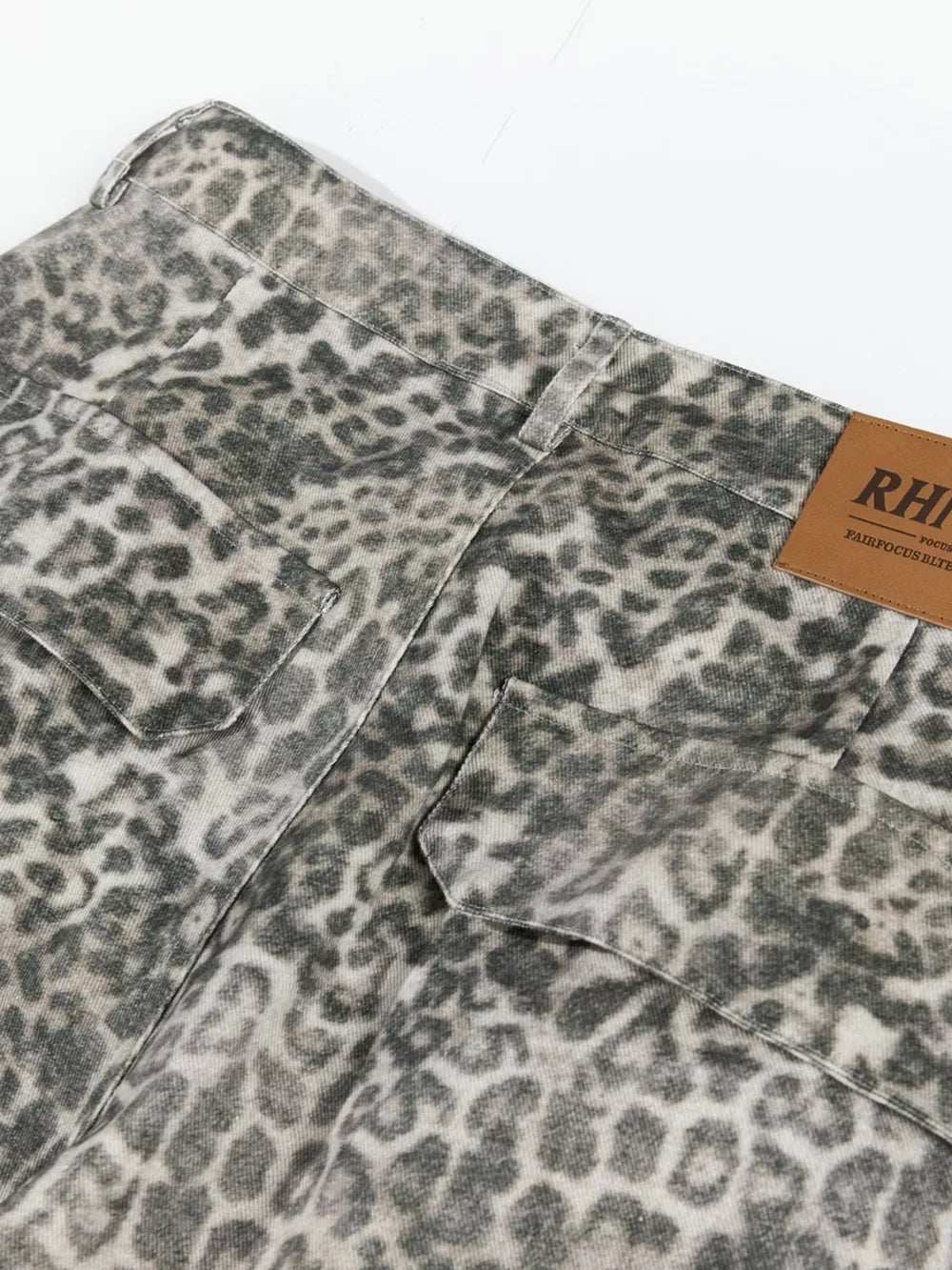 Leopard print cargo pants with utility pockets and button fly.