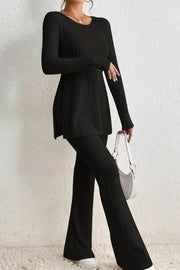 Black ribbed knit co-ord set with flared pants and a side-slit tunic.