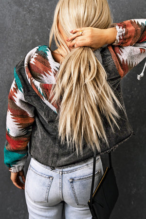 Southwestern print denim hoodie jacket with a dark gray wash and colorful geometric sleeves.