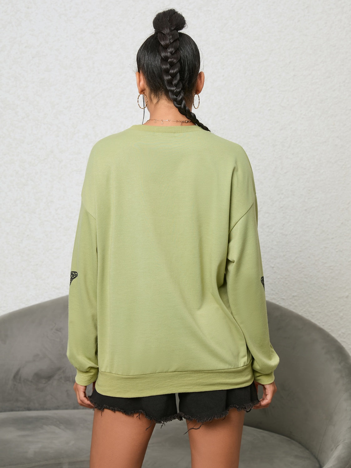 Lime oversized sweatshirt with black butterfly graphic on sleeves
