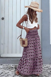 Maxi skirt with geometric print, smocked waist, and tiered ruffle hem.