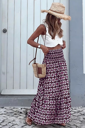 Maxi skirt with geometric print, smocked waist, and tiered ruffle hem.