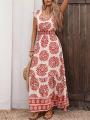 Floral V-neck maxi dress with smocked waist and ruffled sleeves, red floral print on cream.
