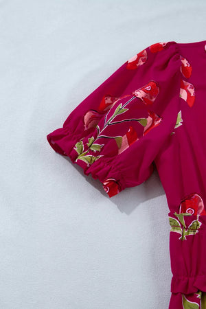 Charming floral tiered midi dress in magenta with puff sleeves and ruffled cuffs.
