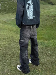 Belted dark grey wide-leg men's jeans with chain detail and pockets.