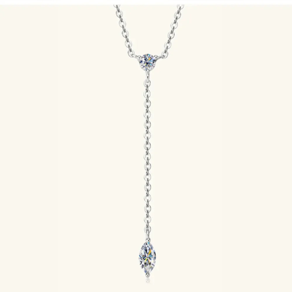 Silver lariat necklace with marquise moissanite pendant and round moissanite accent.
