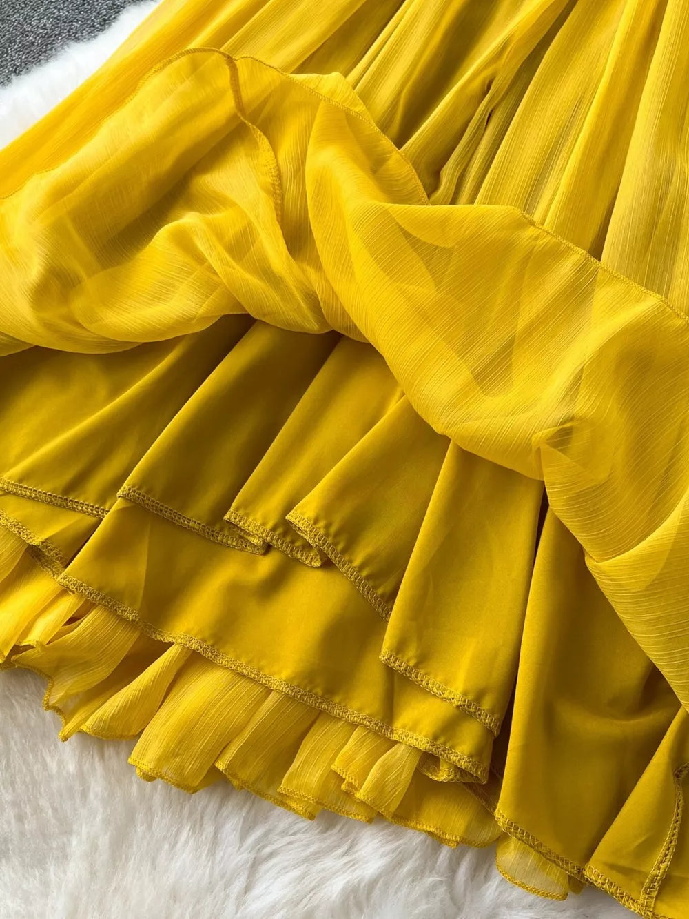 Yellow tiered chiffon dress with ruffled hem detail