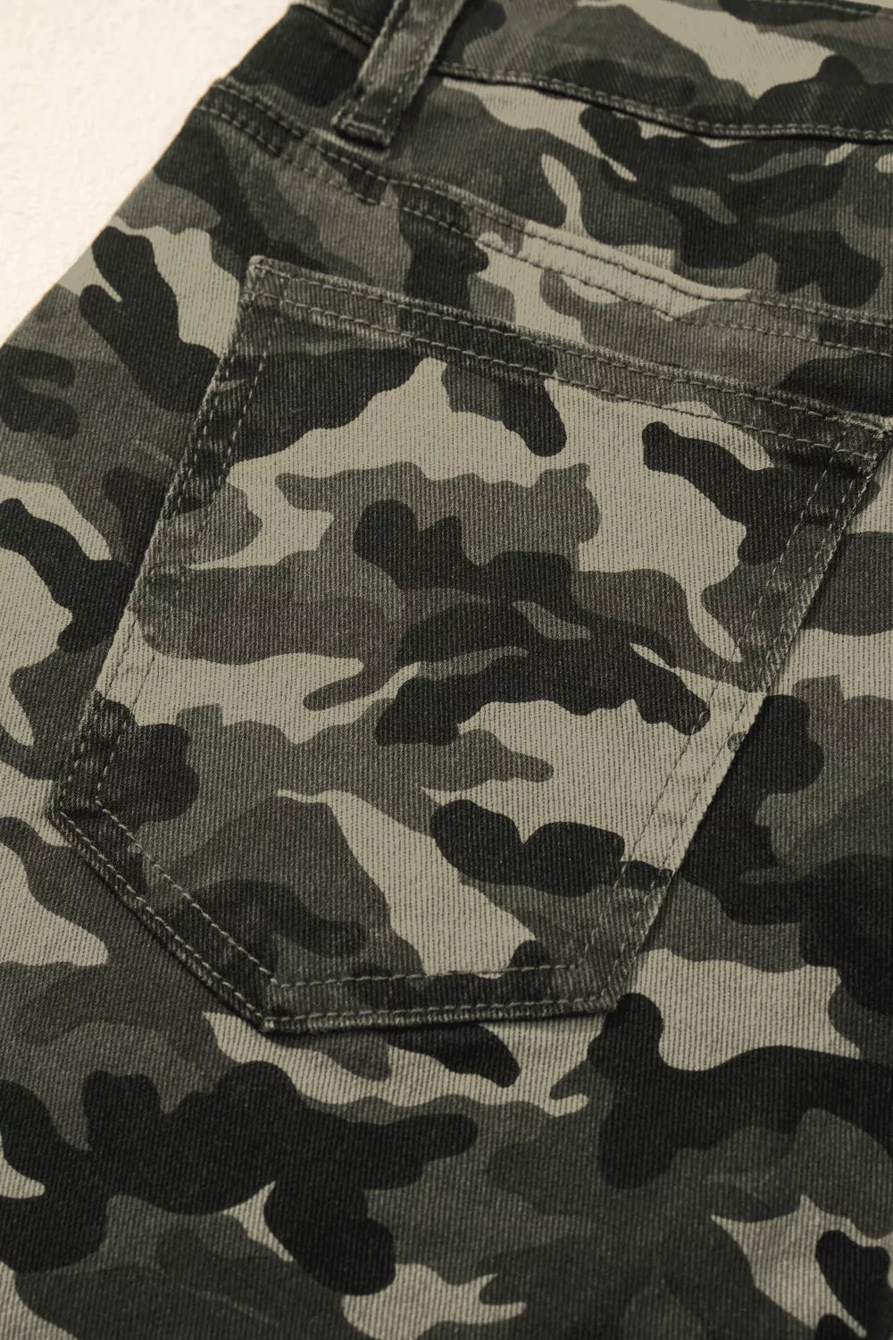 Women's camo print cotton jeans with a back pocket detail.