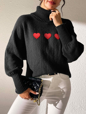 Black turtleneck sweater with balloon sleeves and red heart appliqués.