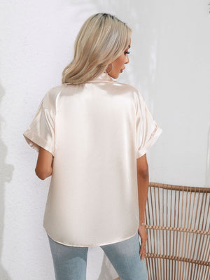 Champagne satin boxy sleeve blouse with cuffed sleeves and a button-down collar.