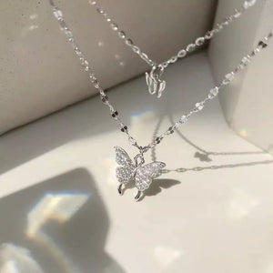 Elegant double-layer necklace with a sparkling butterfly charm in white gold.