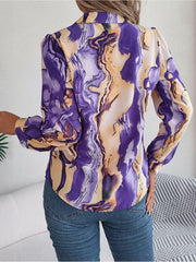 Women's abstract swirl print silk blouse in purple and yellow with button details.