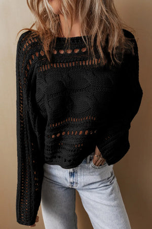 Black cable knit sweater with cutout details and long sleeves.