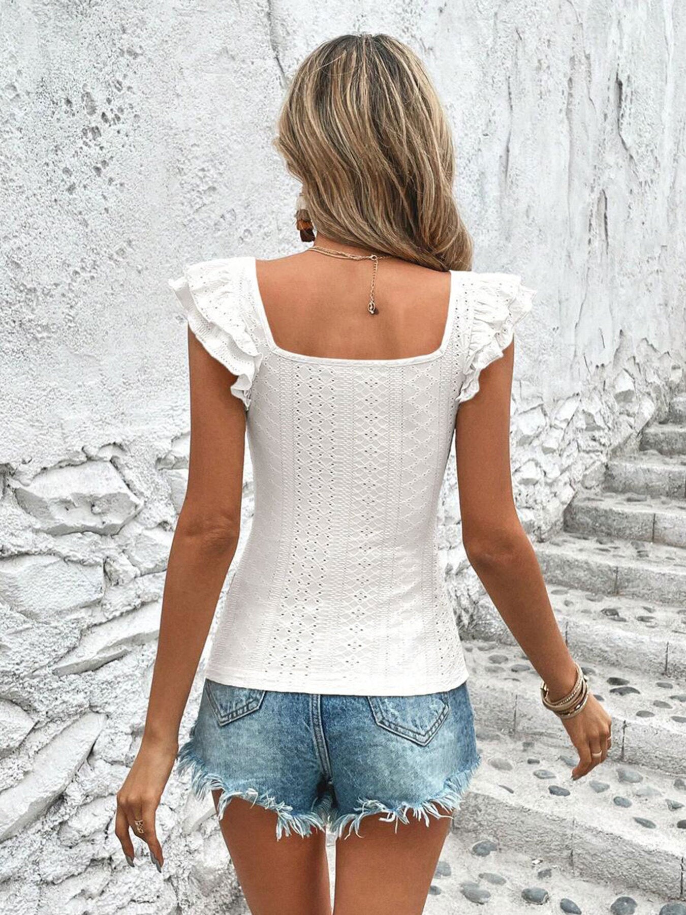 White ruffled square neck t-shirt with cap sleeves and eyelet detail.