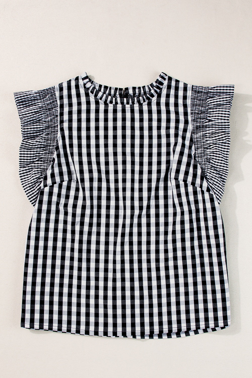 Black gingham ruffle sleeve mock neck blouse with ruffled sleeves.