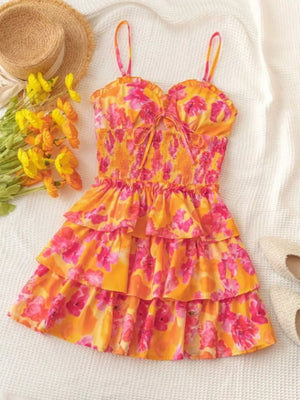 Floral cutout tiered mini dress with smocked bodice and tie front.