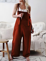 Burgundy linen tie-strap jumpsuit with patch pockets and wide legs.