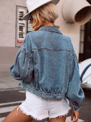 Medium wash denim cropped jacket with balloon sleeves and collared neckline.