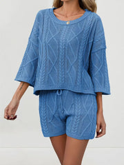 Blue cable-knit two-piece sweater set with 3/4 sleeves and drawstring shorts.