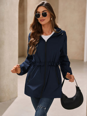 Navy hooded windbreaker jacket with ruffled drawstring waist and zip pockets