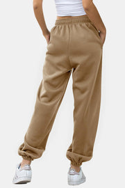 Relaxed-fit tan sweatpants with cuffed ankles and pockets.