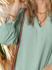 Light Green smocked long sleeve blouse with V-neck and lace detail on sleeve cuff