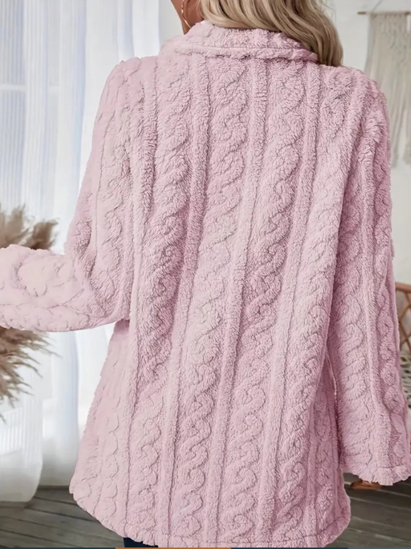 Pink faux shearling coat with cable knit texture and a collared neckline.