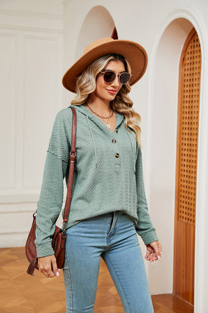 Green textured henley hoodie with drop shoulder and button placket.