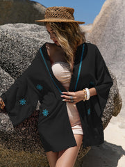 Black embroidered kimono cover-up with contrast stitching and floral details.