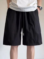 Black relaxed fit drawstring shorts for men with white tips and side pocket detail.