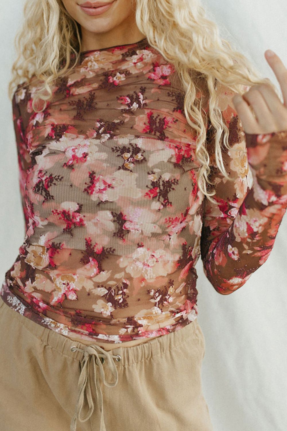 Sheer floral mock neck top with second-skin fit and long sleeves.