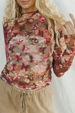 Sheer floral mock neck top with second-skin fit and long sleeves.