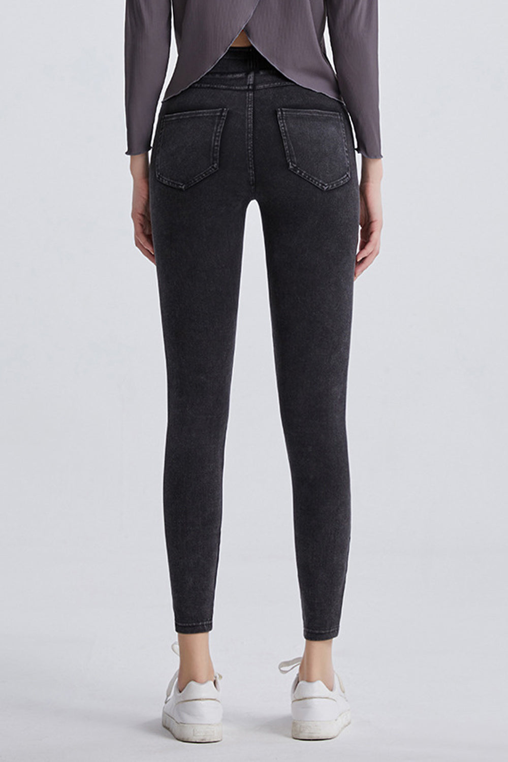 Dark gray denim leggings with faux pockets and a slim fit.