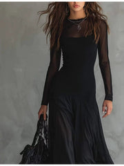 Black sheer mesh maxi dress with long sleeves and a ruffled neckline.