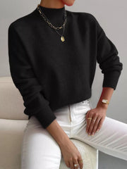Black mock neck sweater with dropped shoulders, ribbed cuffs and hem.