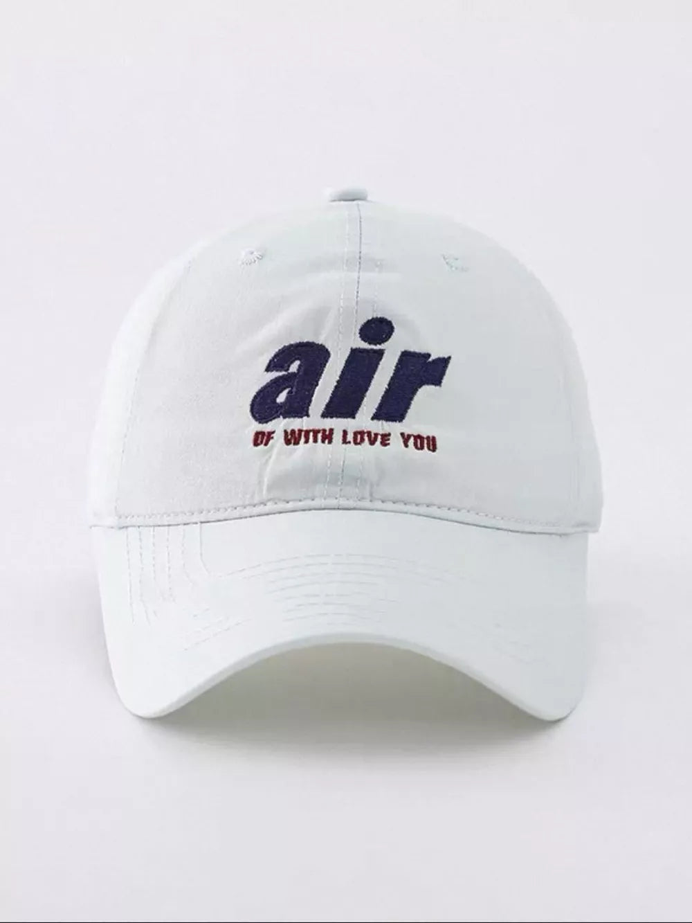 White baseball cap with embroidered "air" and "of with love you" text.